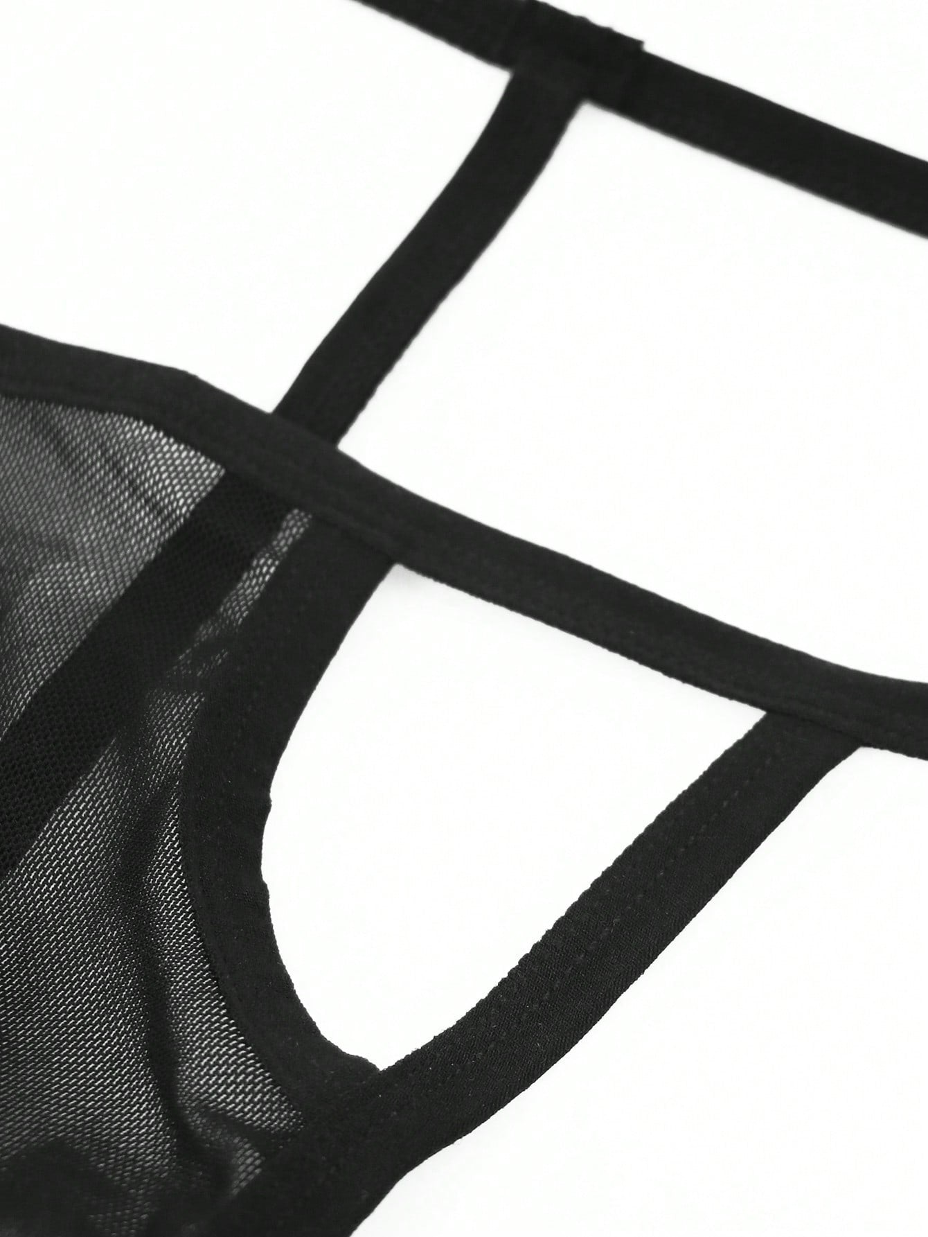 Black men's mesh thong underwear with colorblock design, mid-rise waist, and medium-stretch fabric for couple lingerie styling.