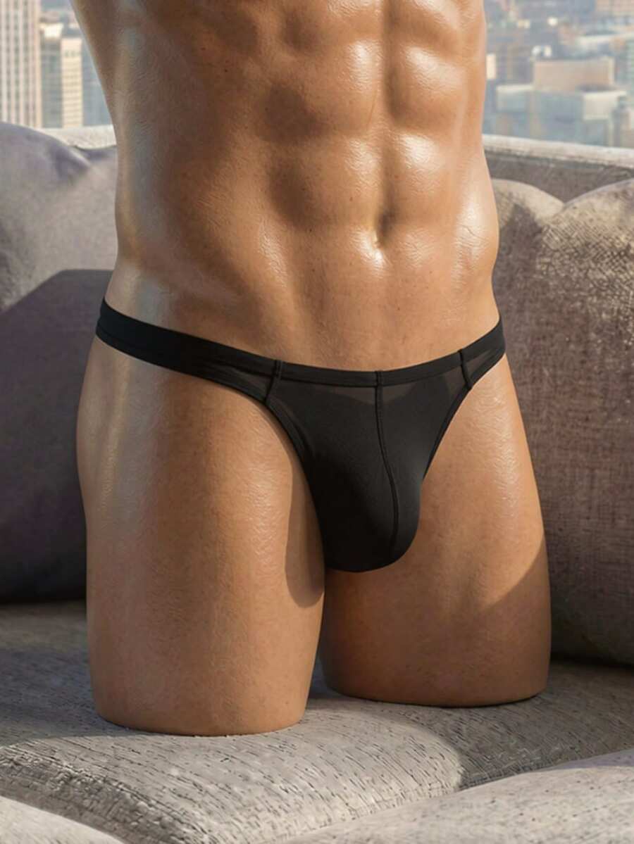 Men's solid color low-rise hollow out thong underwear made of flexible stretch fabric.
