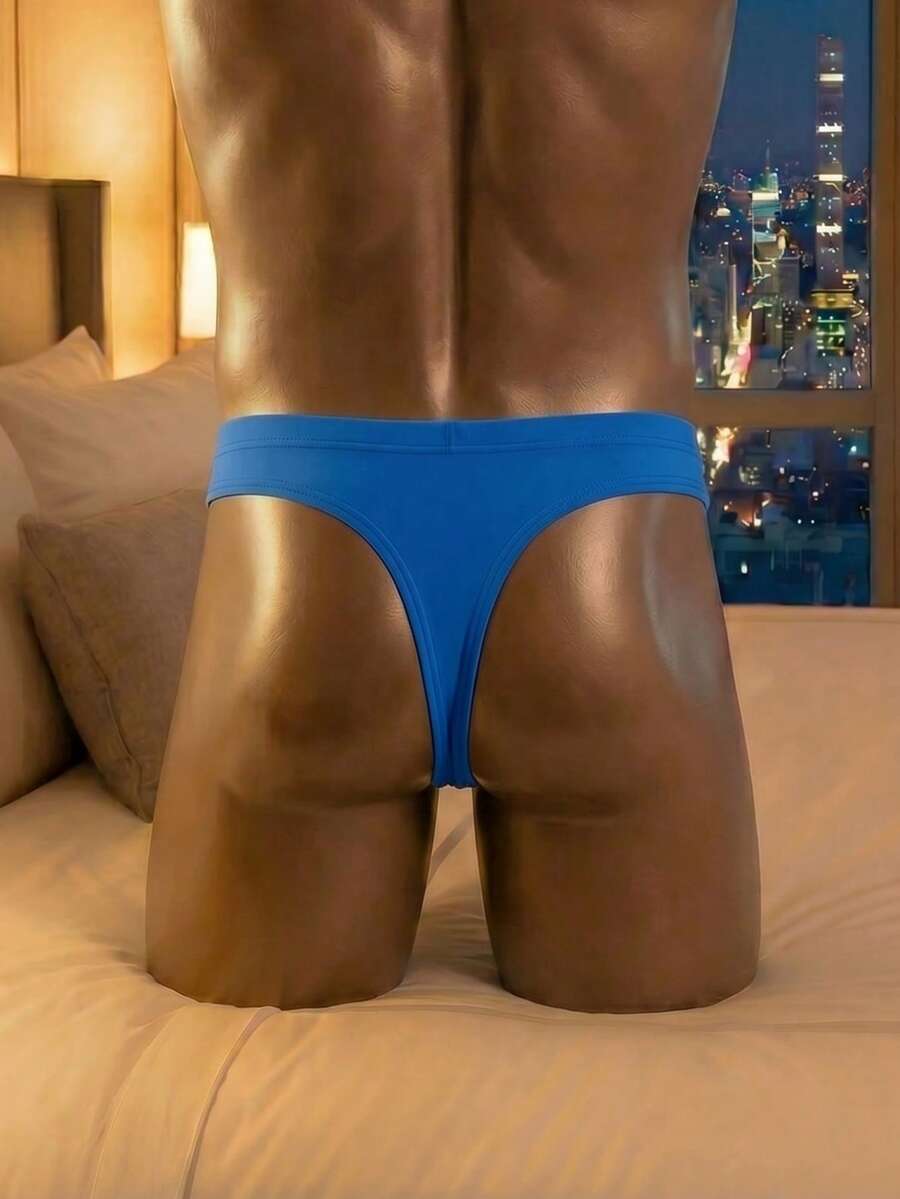 Men's solid color low-rise hollow out thong underwear made of flexible stretch fabric.