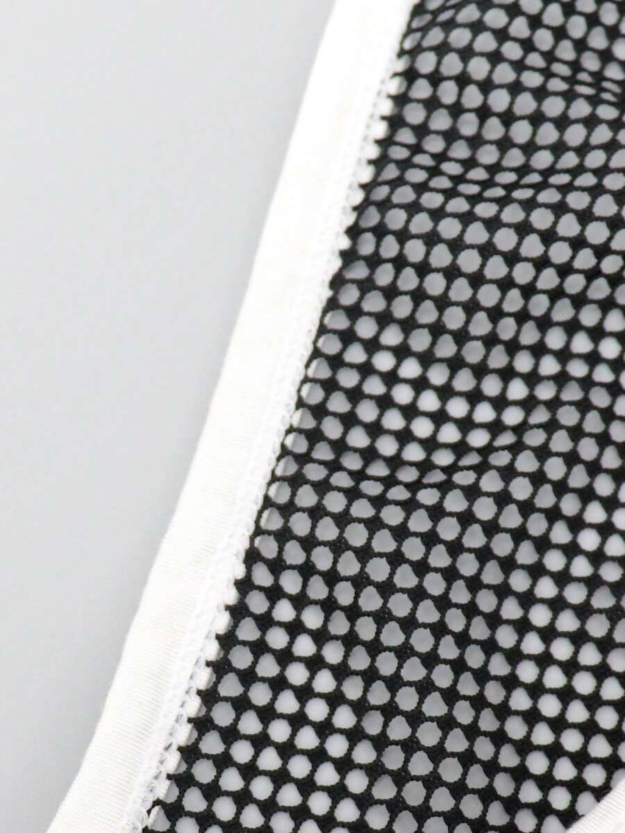 Black low-rise men's mesh briefs featuring contrast binding and tape details