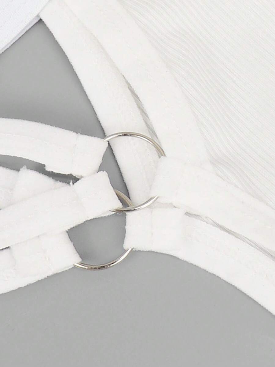 Men's black low-rise thong underwear with a ring-connected hollow design in knitted stretch fabric.