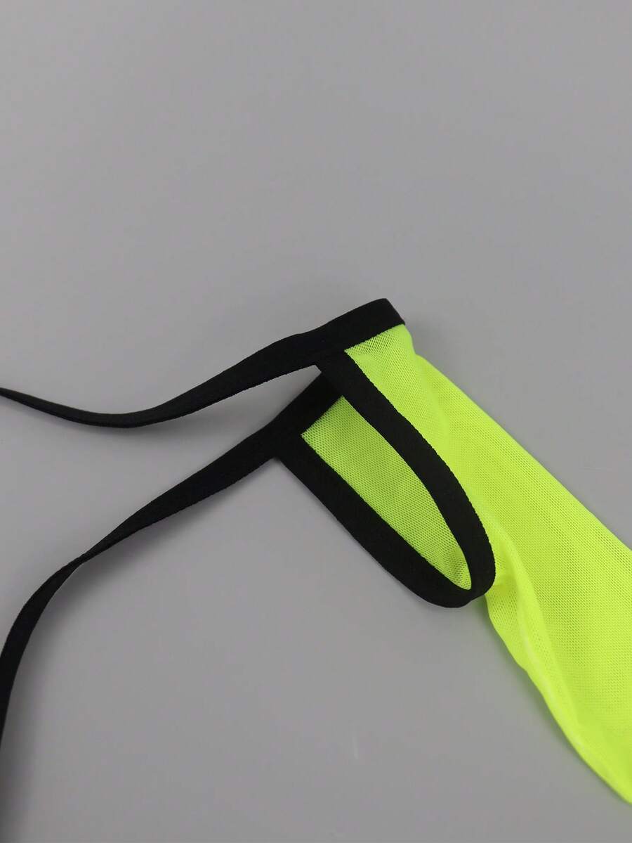 Yellow mesh jockstrap for men with a mid-rise waist, hollow U-convex pouch design, and breathable stretch polyamide fabric.