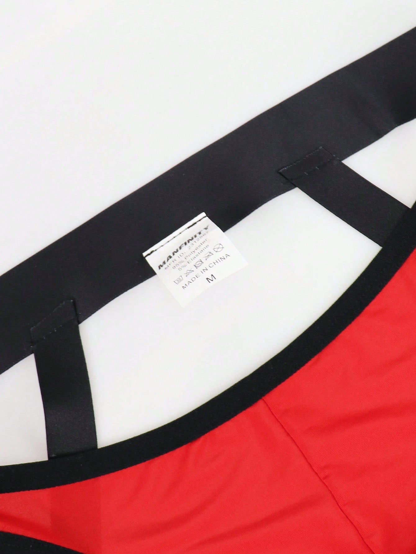 Men's solid color jockstrap underwear in knitted fabric with a breathable hollow design, low rise fit, plain pattern, and medium stretch for daily wear.