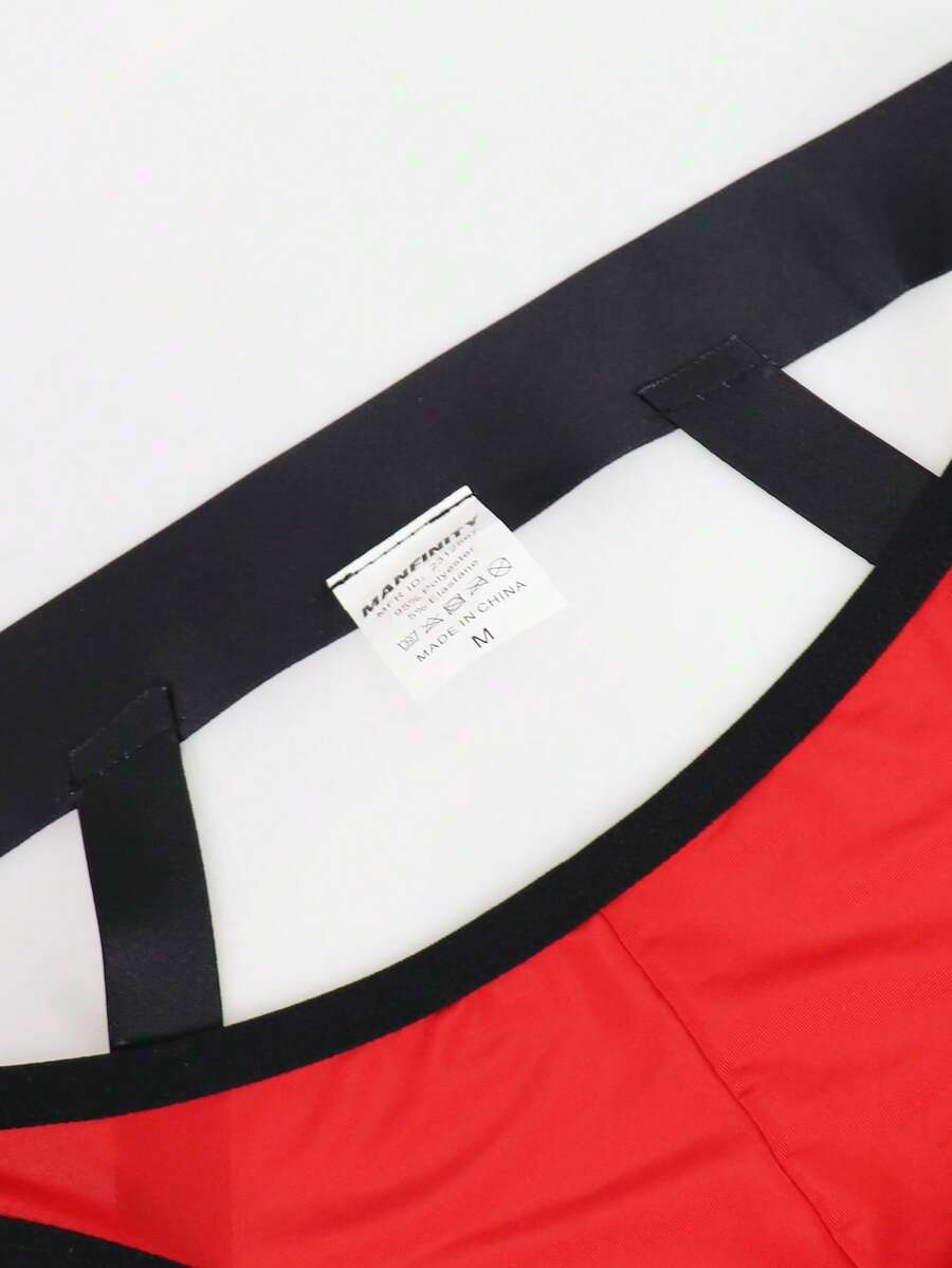 Red men's low-rise jockstrap underwear featuring criss-cross cut-out details in medium stretch knitted fabric.