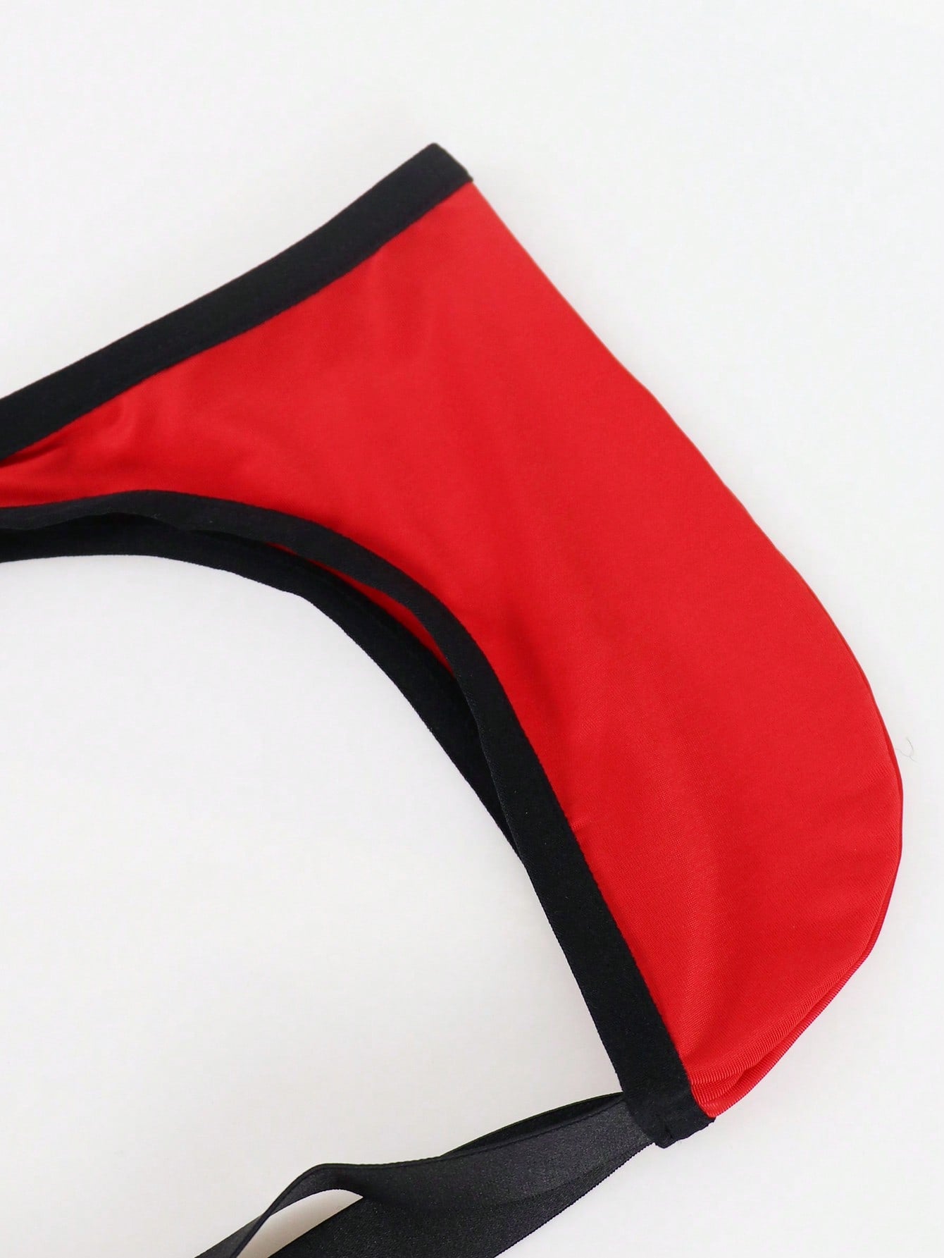 Men's solid color jockstrap underwear in knitted fabric with a breathable hollow design, low rise fit, plain pattern, and medium stretch for daily wear.