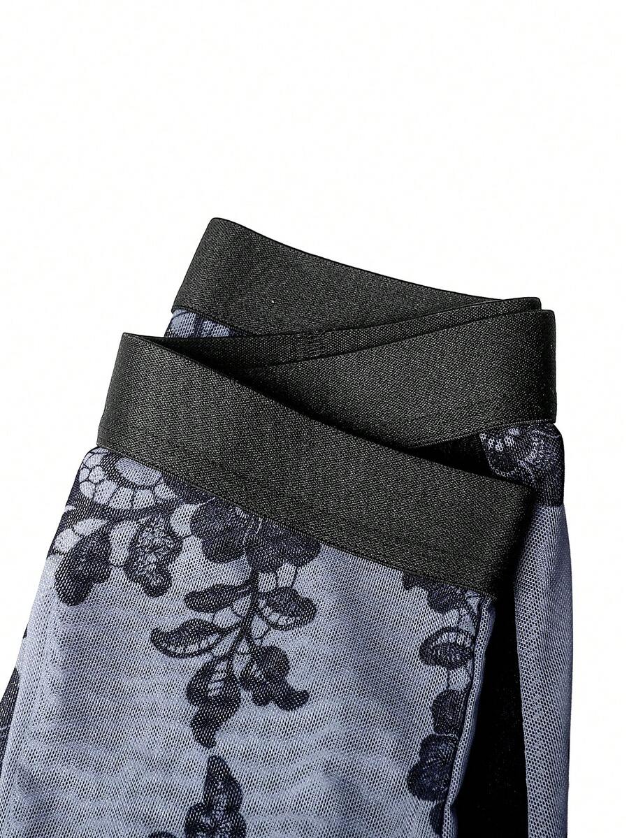 Black mid-rise men's boxer briefs featuring contrast binding and semi-sheer high-stretch fabric with a Halloween pattern.