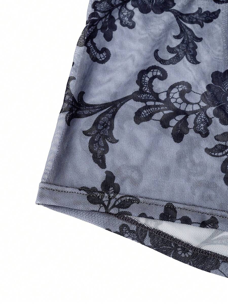 Black mid-rise men's boxer briefs featuring contrast binding and semi-sheer high-stretch fabric with a Halloween pattern.