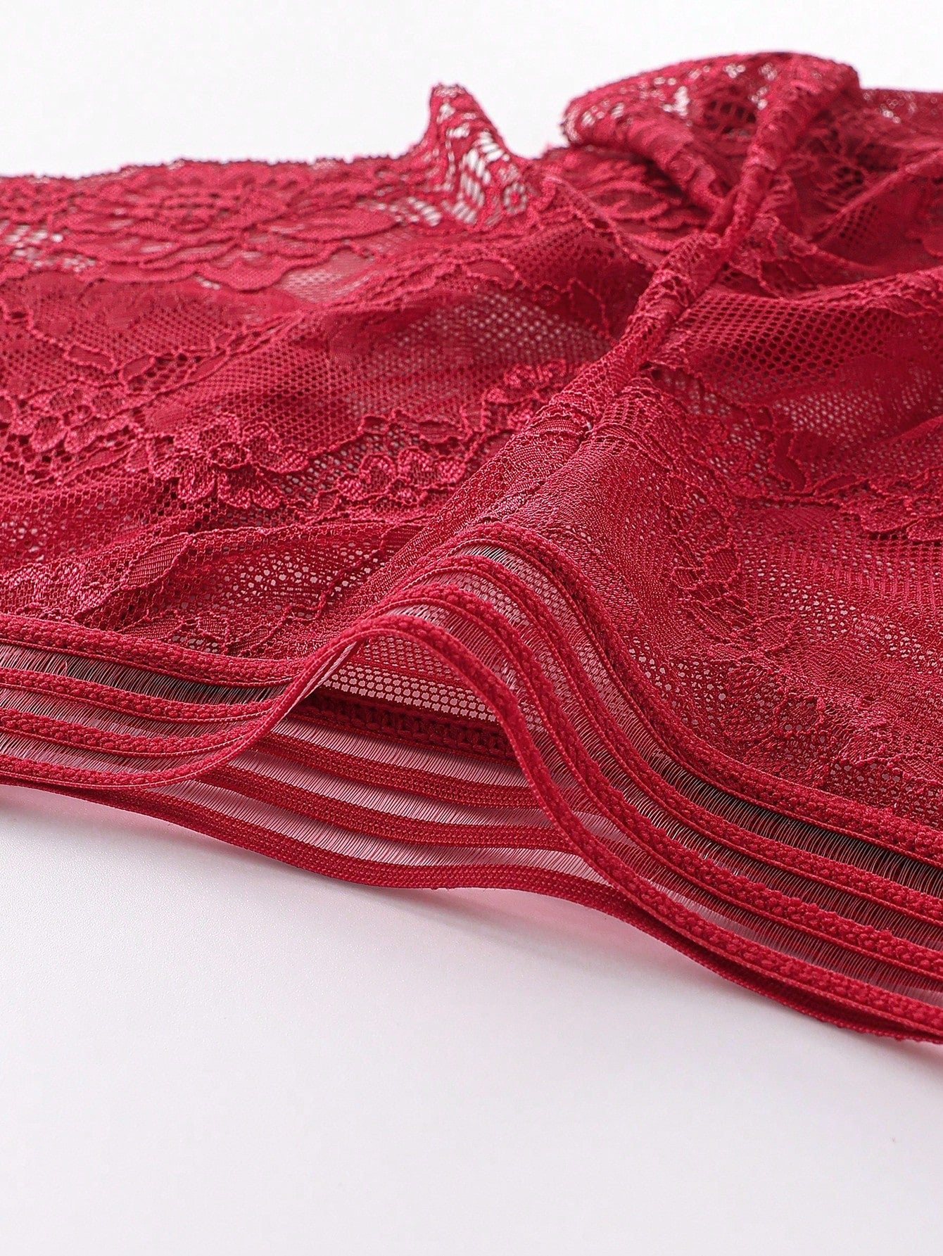 Men's semi-sheer lace briefs in burgundy with a geometric pattern, mid-rise fit, and medium-stretch knitted fabric.