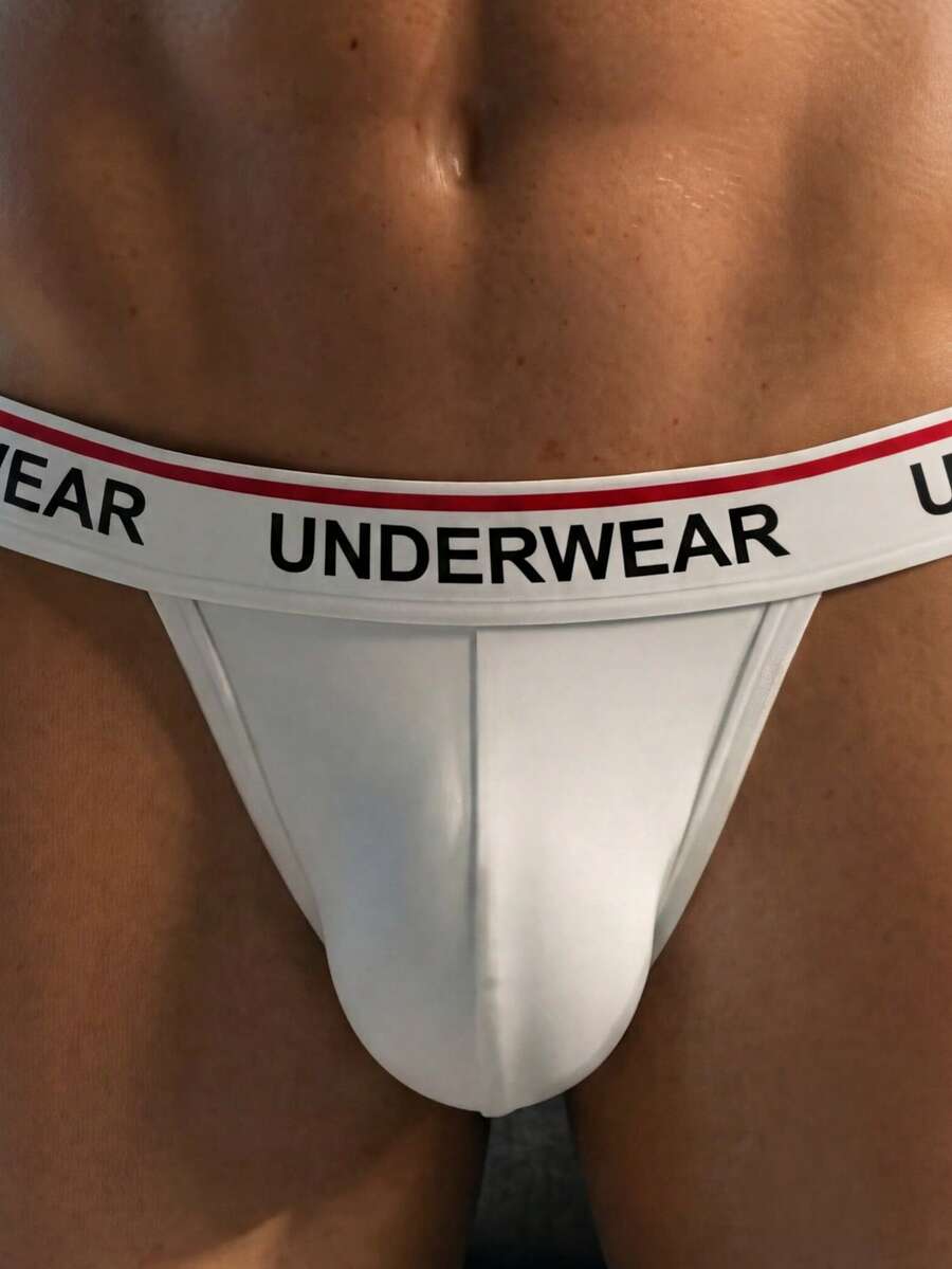 Low rise men's thong underwear with rhinestone letter print detail.