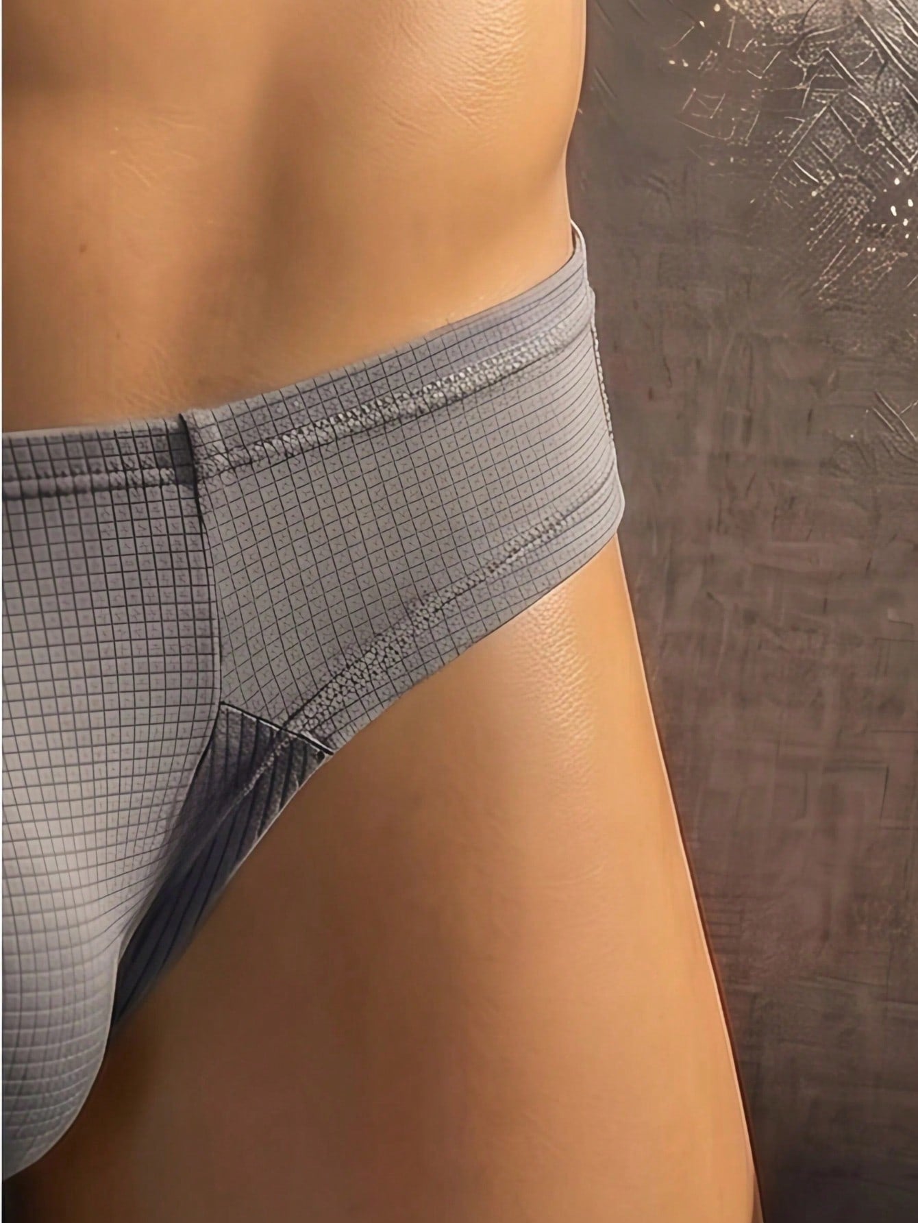 Men's soft thong underwear with low rise fit, plain design, and T-back style in polyester elastane fabric