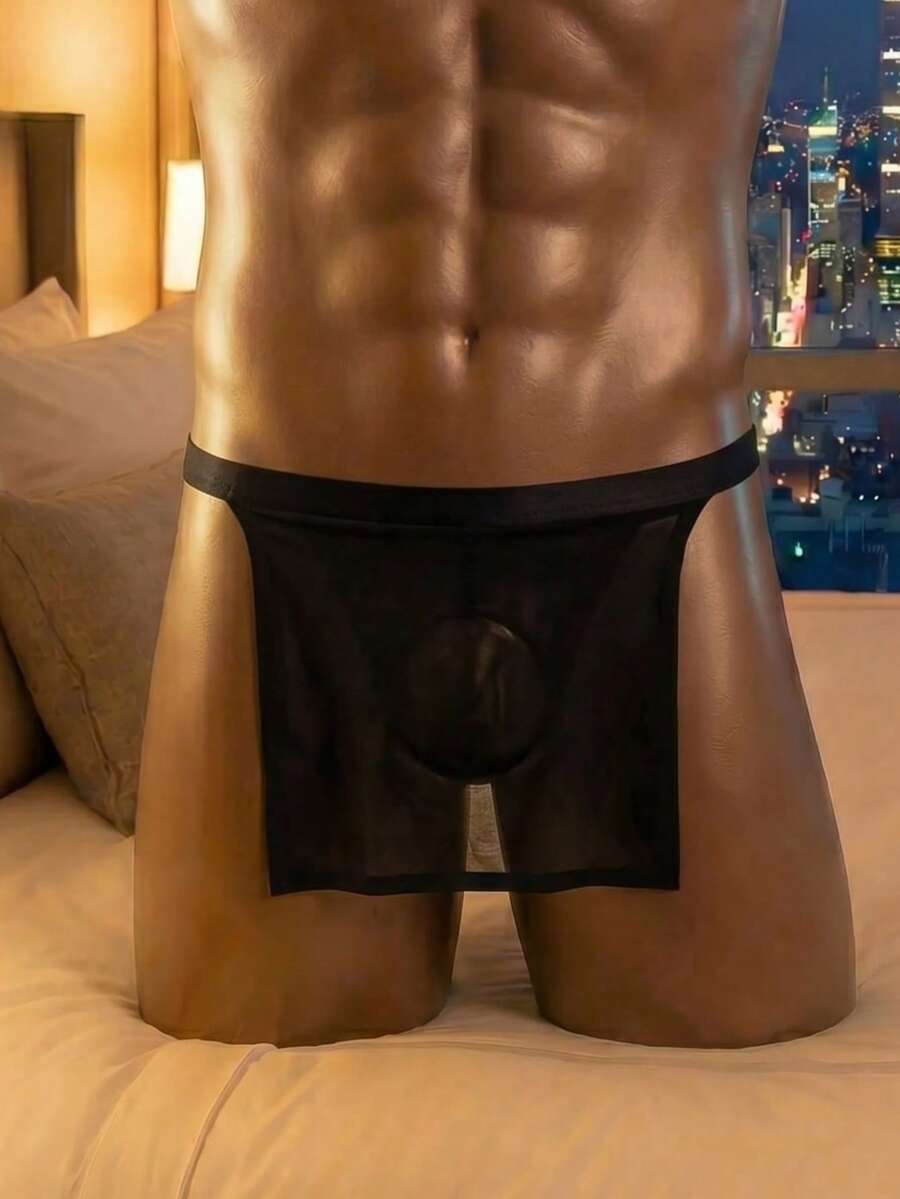 Front view of a men's black low rise thong underwear made from stretch fabric.