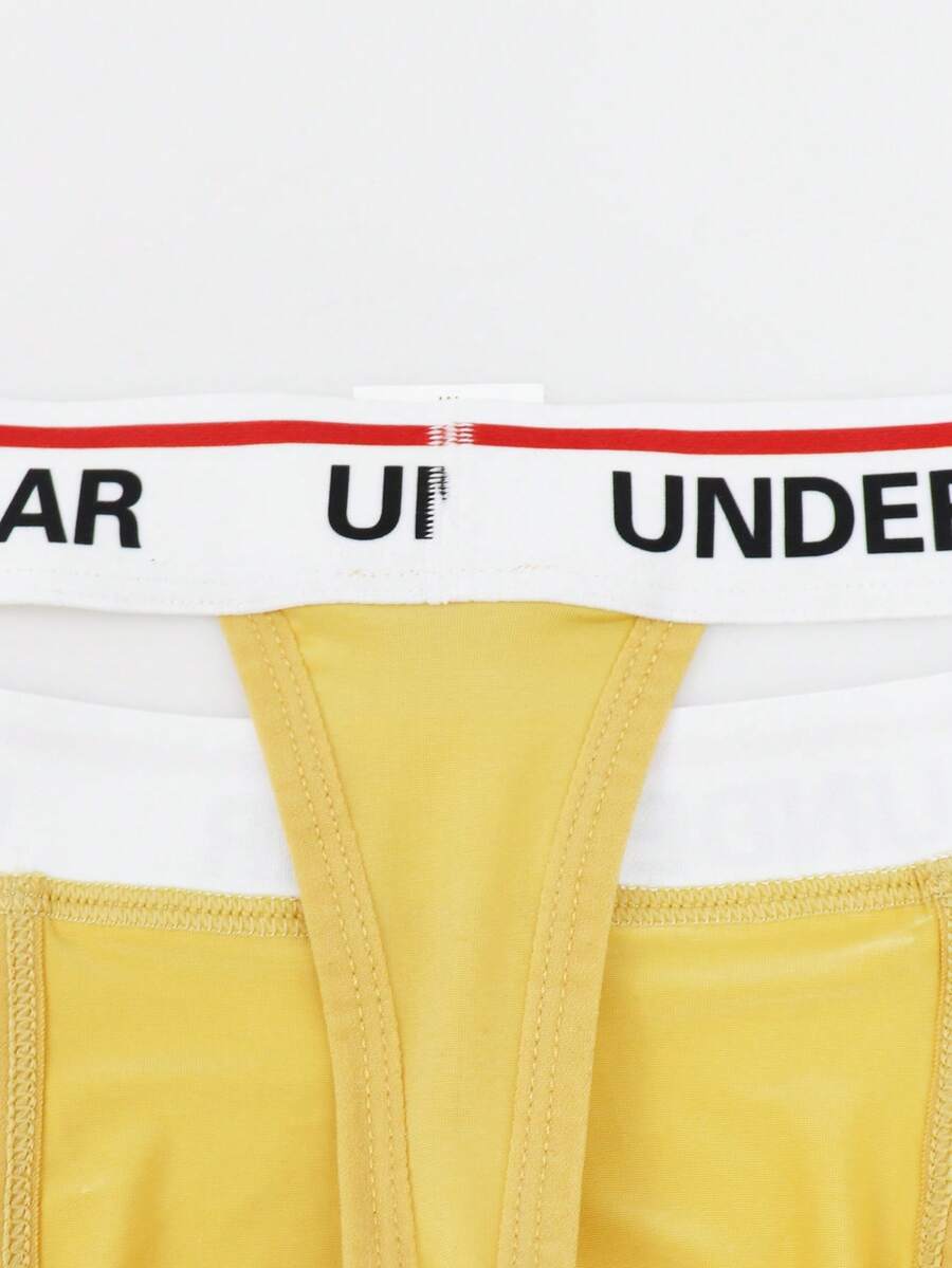 Low rise men's thong underwear with rhinestone letter print detail.