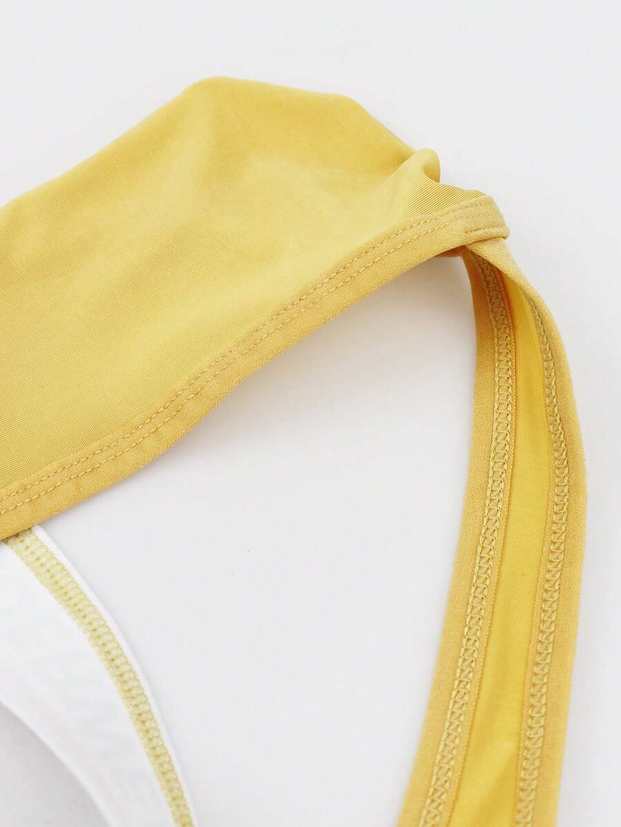 Low rise men's thong underwear with rhinestone letter print detail.