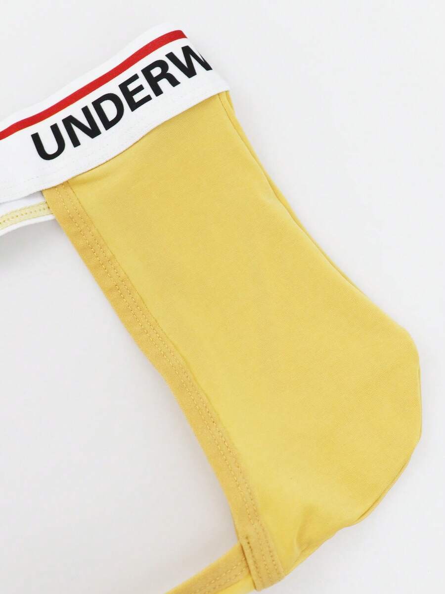 Low rise men's thong underwear with rhinestone letter print detail.