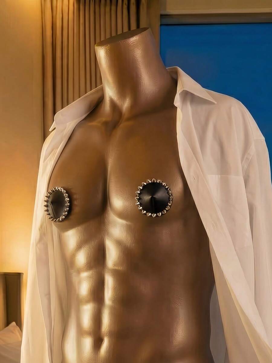 Single black rivet-decorated studded nipple cover for men made of metallic 100% viscose fabric.