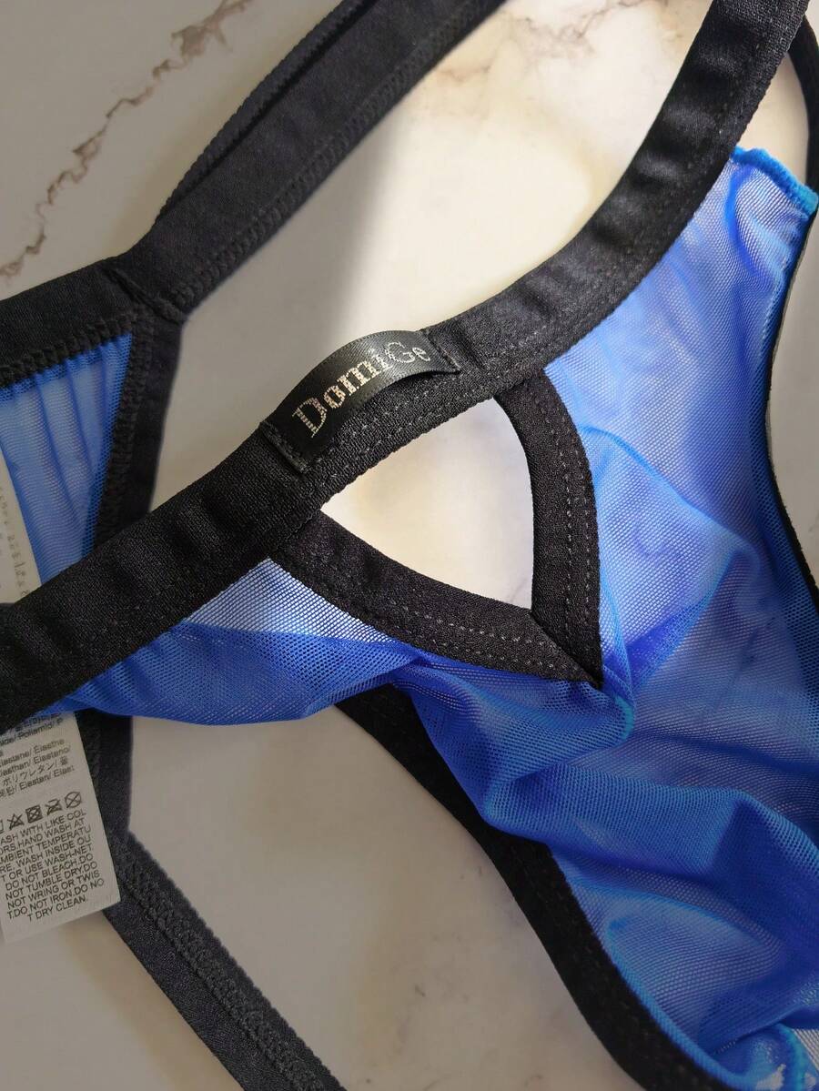 Men's black mesh G-string thong underwear featuring a low-waist cut-out front design.