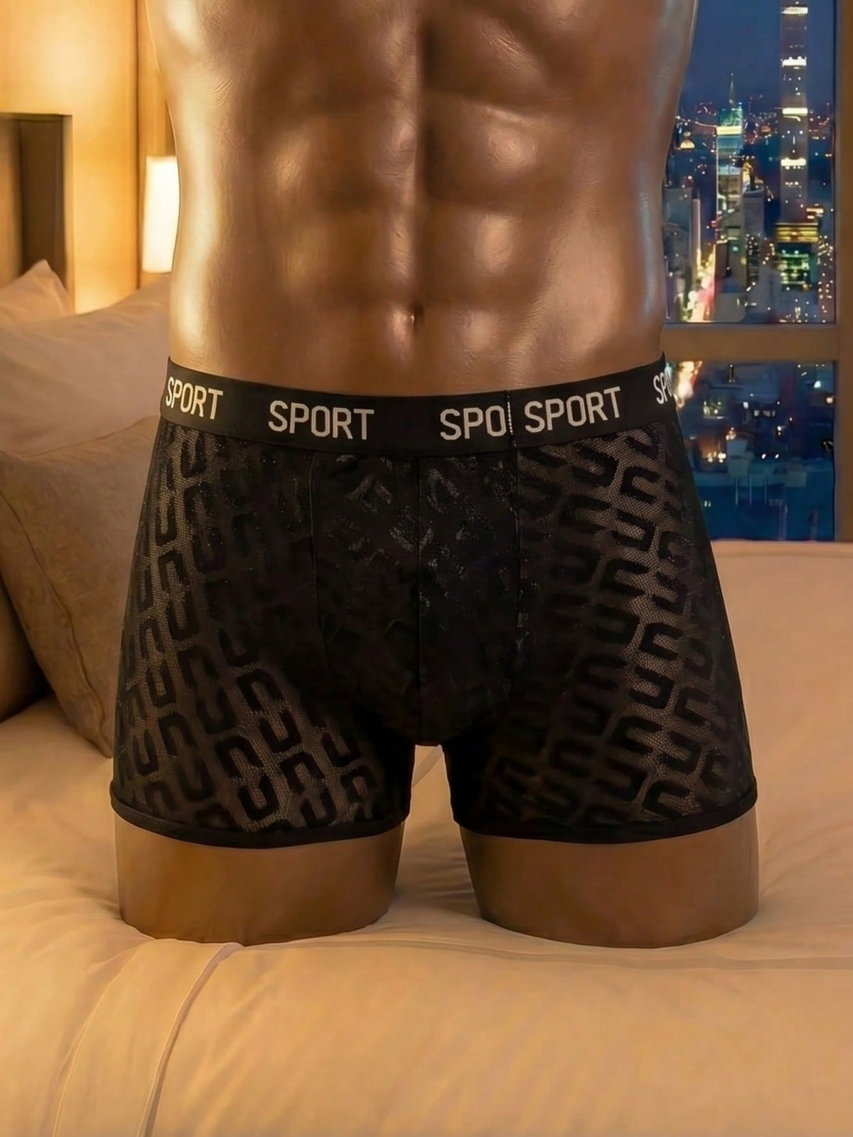 Men's black low rise boxer shorts featuring tape detail and letter pattern.