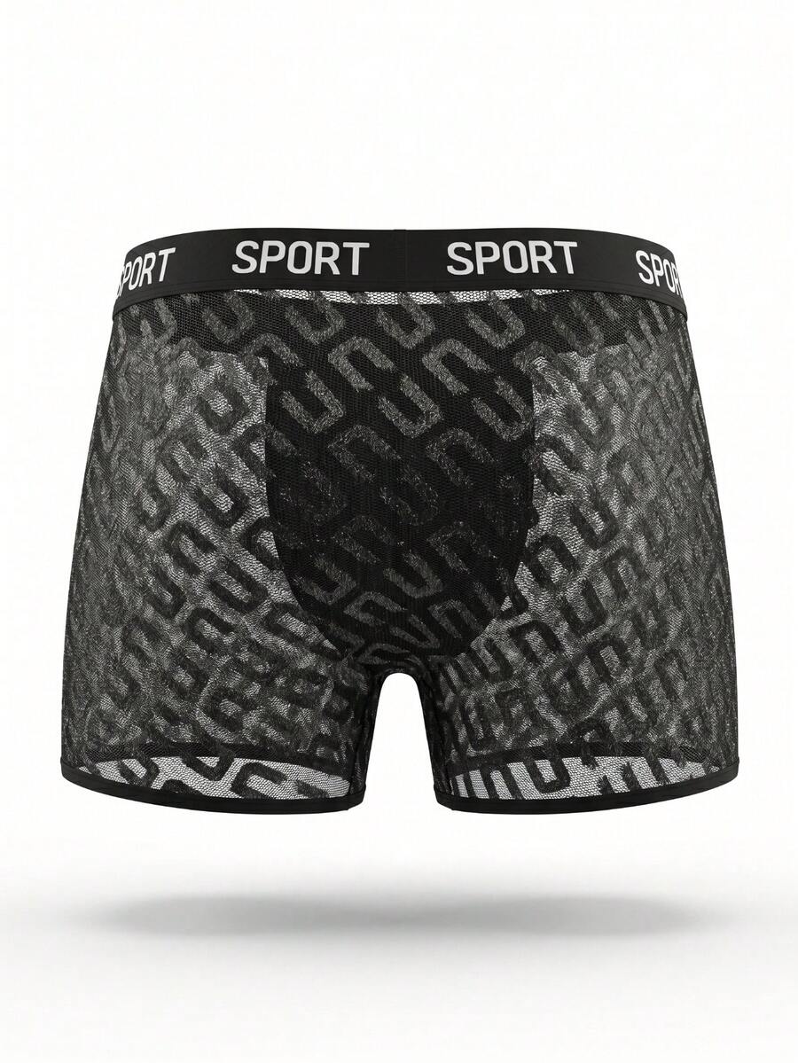 Men's black low rise boxer shorts featuring tape detail and letter pattern.