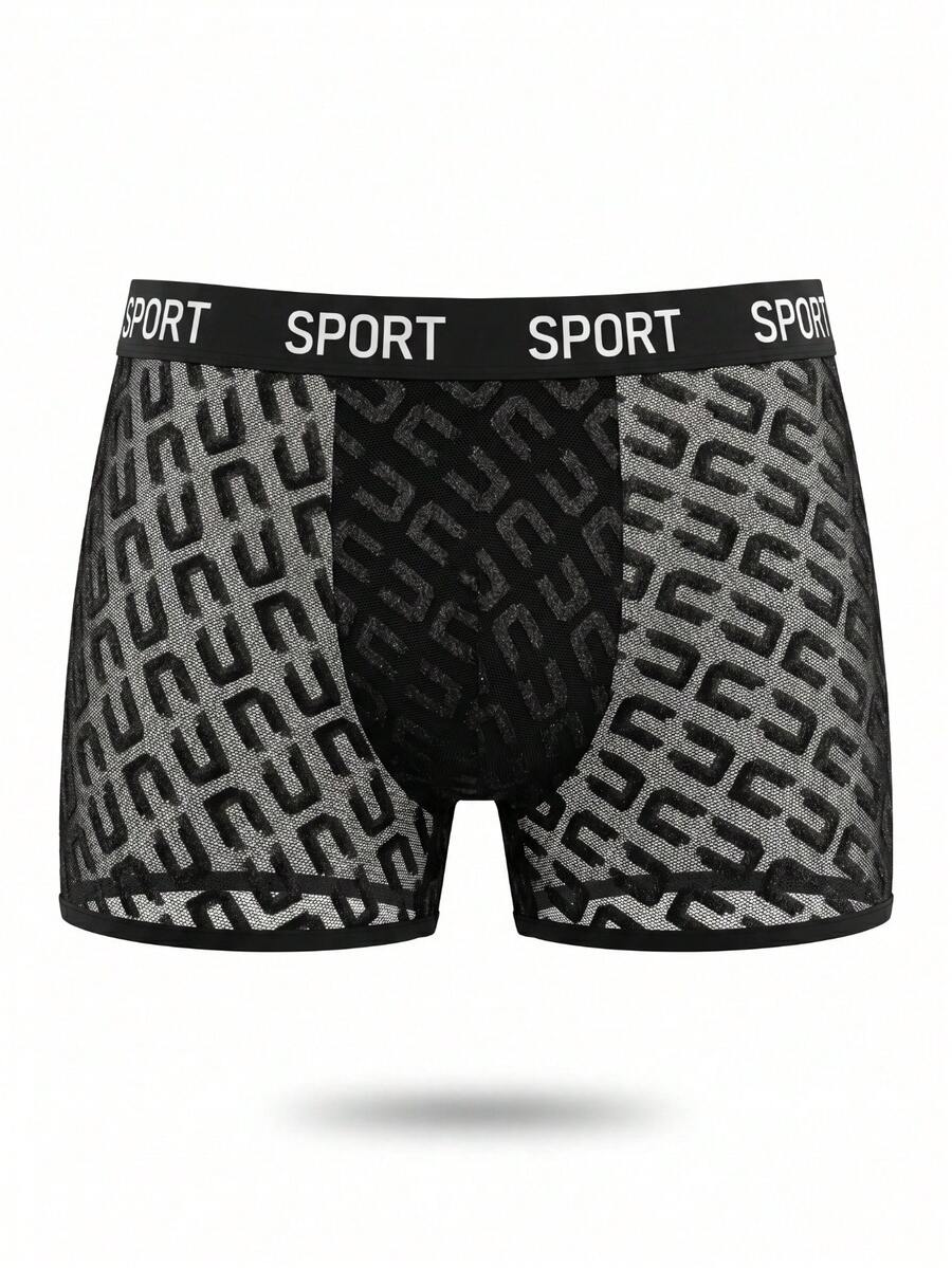 Men's black low rise boxer shorts featuring tape detail and letter pattern.