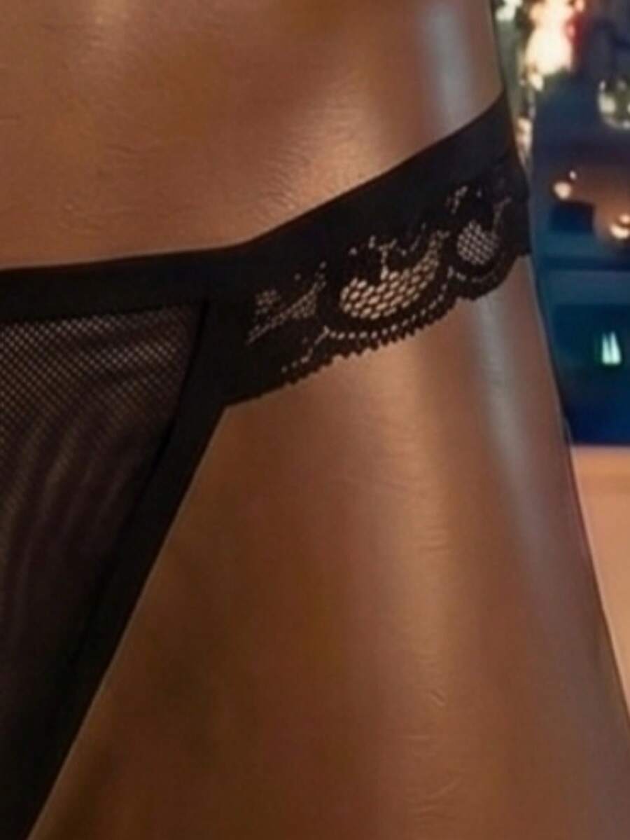 Men's black hollow mesh jockstrap featuring a lace waistband, low-rise fit, backless design, and double pouch.