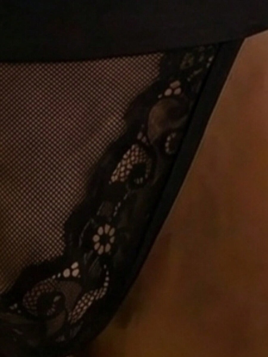 Black low rise men's mesh jockstrap featuring hollow out back waist design with lace trim.