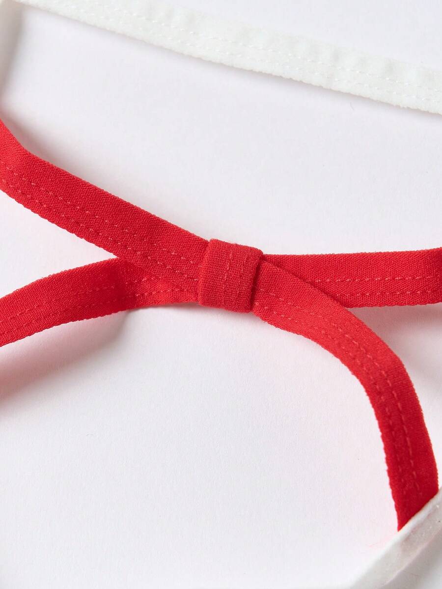 Men's low rise colorblock thong underwear in red and white knitted fabric.