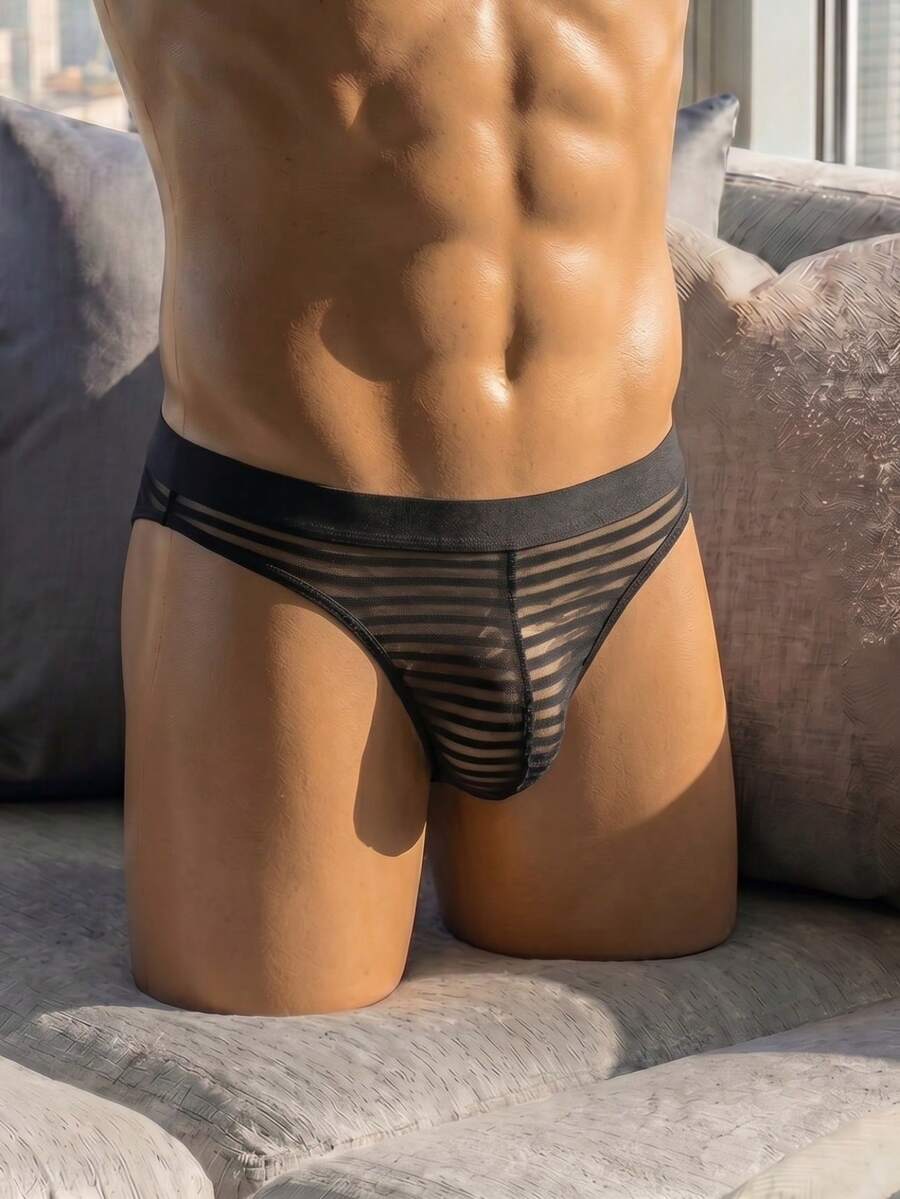 Black men's semi-sheer low rise thong underwear made from medium stretch knitted fabric.