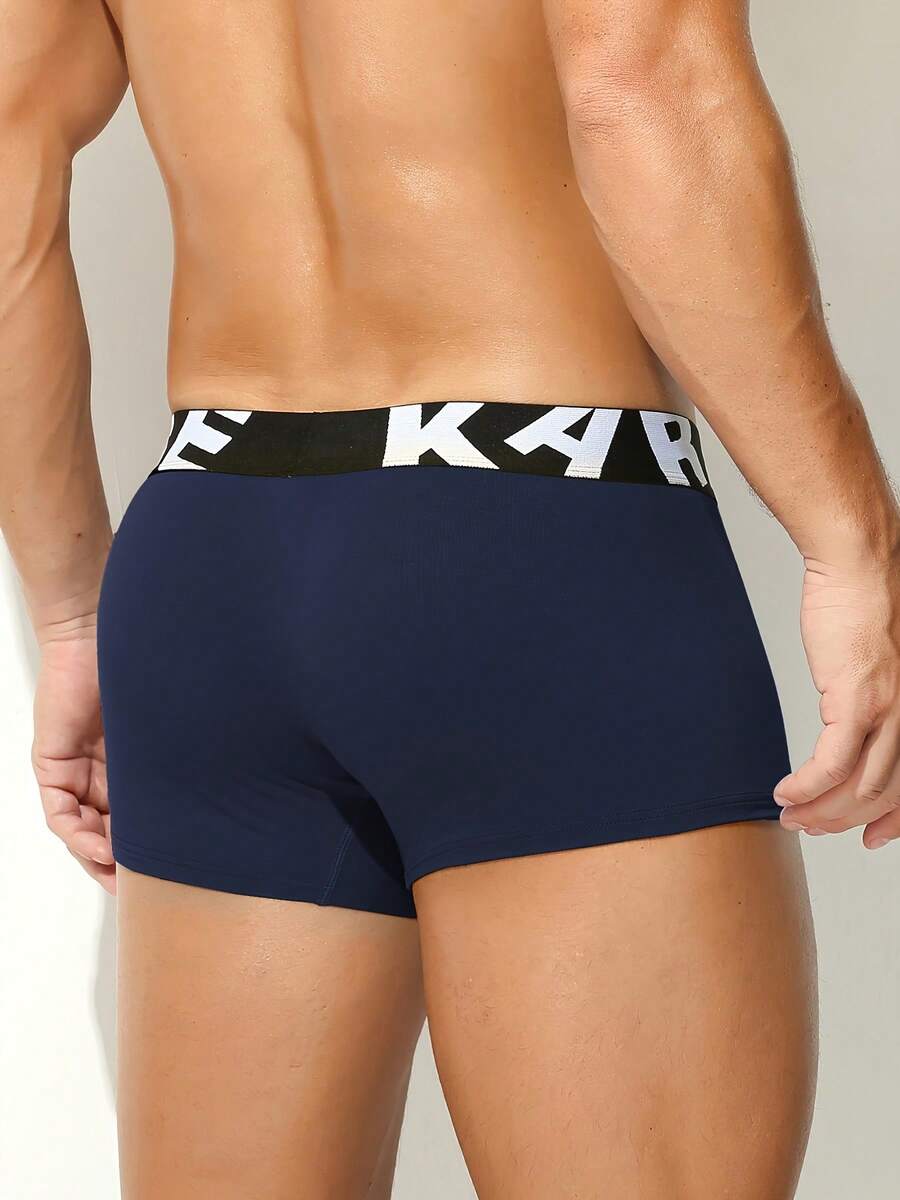 Men's sporty underwear trunks in royal blue featuring an opening pouch design, mid-rise elastic waistband, and colorblock patched details.