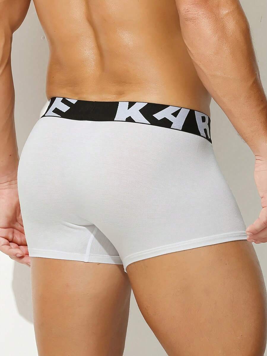 Men's sporty underwear trunks in royal blue featuring an opening pouch design, mid-rise elastic waistband, and colorblock patched details.