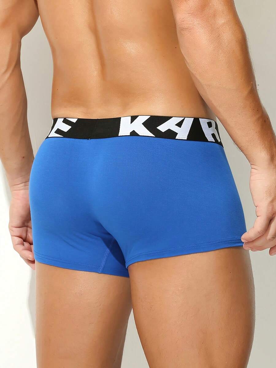 Men's sporty underwear trunks in royal blue featuring an opening pouch design, mid-rise elastic waistband, and colorblock patched details.