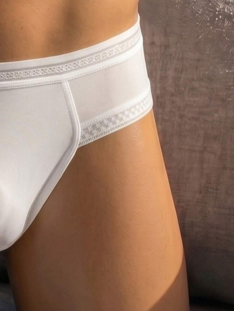 White low rise men's lace trim briefs with medium stretch fabric.