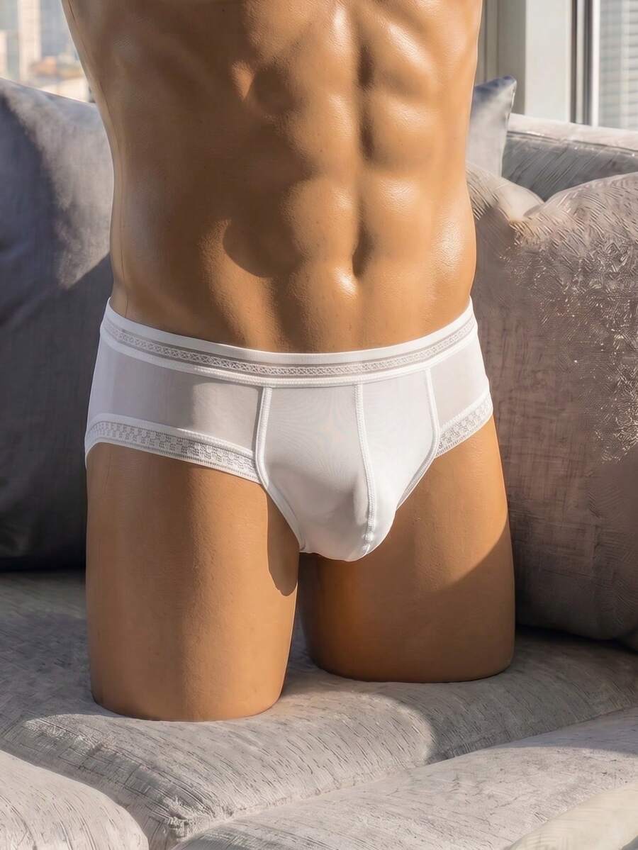 White low rise men's lace trim briefs with medium stretch fabric.