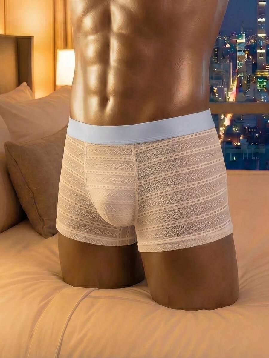 White men's mesh boxer shorts featuring cut out details, mid-rise waist, and a striped pattern design.