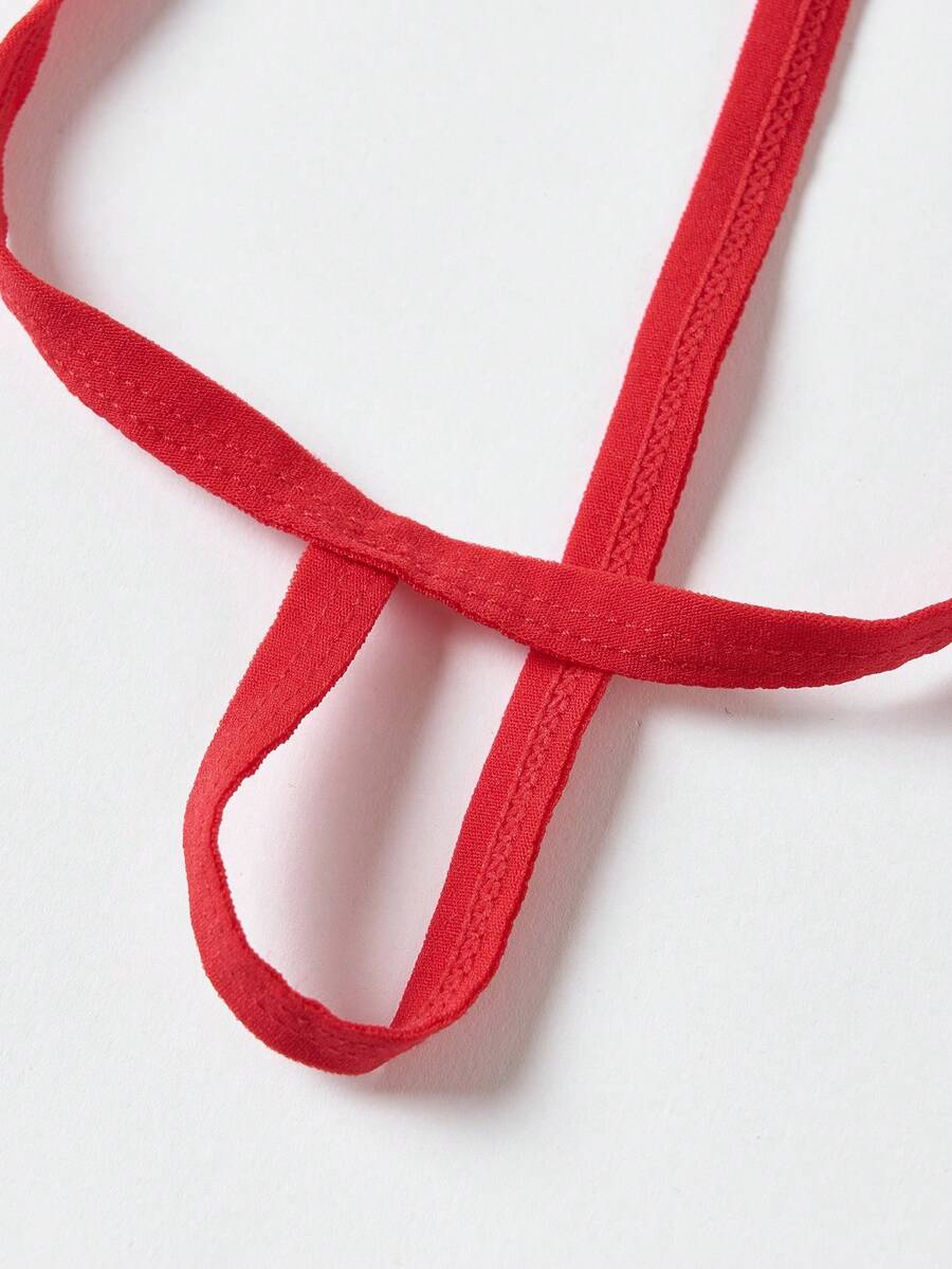 Red men's T-back thong underwear featuring a low-rise fit, colorblock pattern, and anti-slip chain detail.