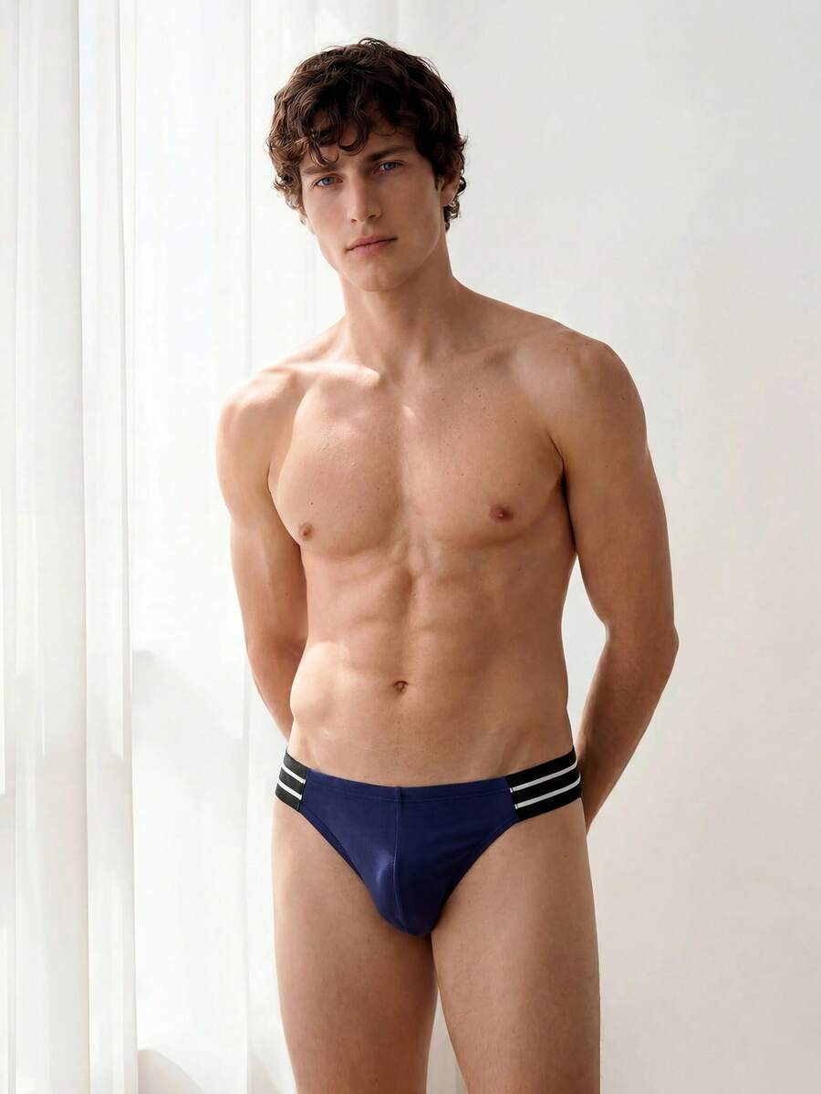 Navy blue men's mid rise sporty brief with cut out detail made from soft knitted stretch fabric.
