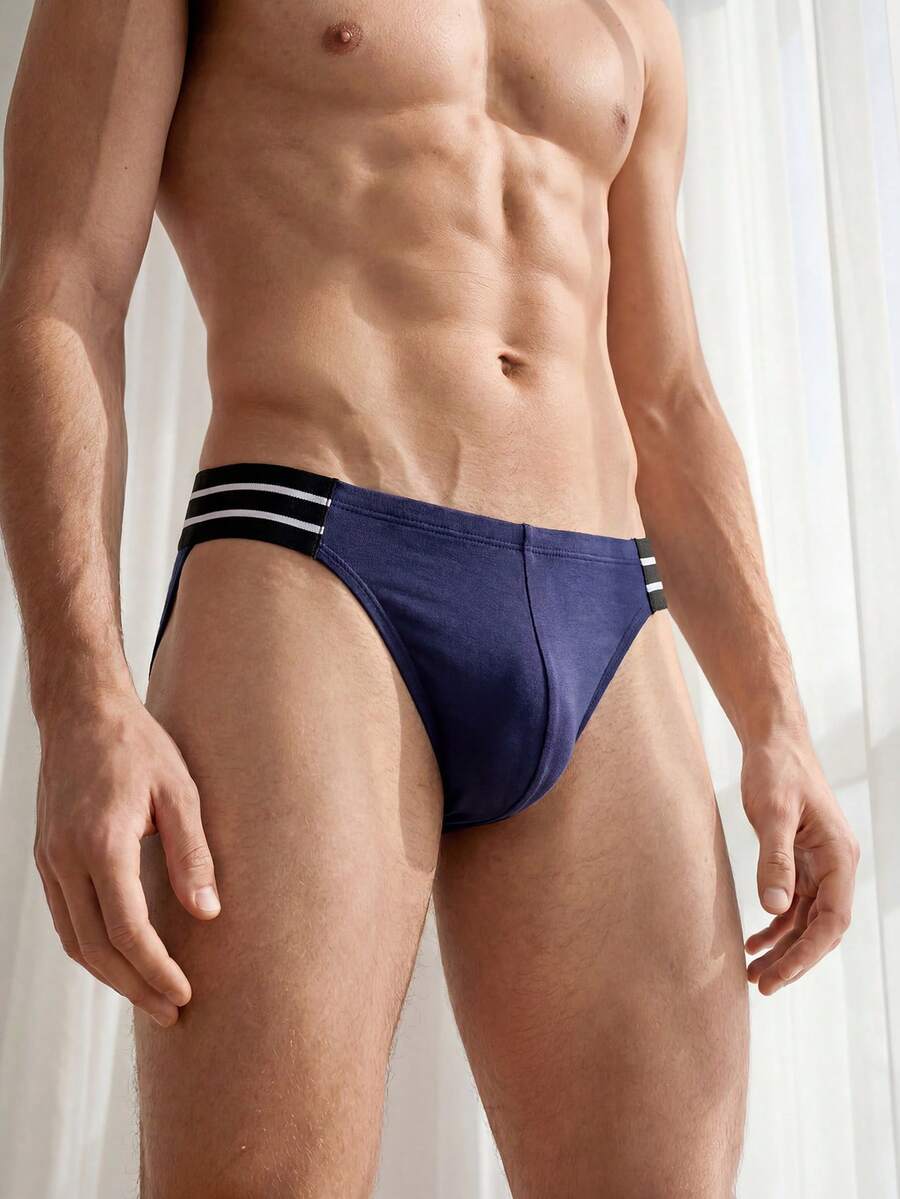 Navy blue men's mid rise sporty brief with cut out detail made from soft knitted stretch fabric.