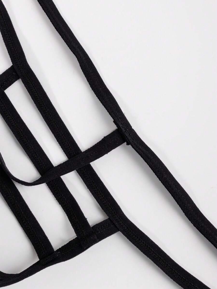 Black low-rise men's T-back thong underwear featuring an anti-slip design made from knitted medium-stretch fabric.