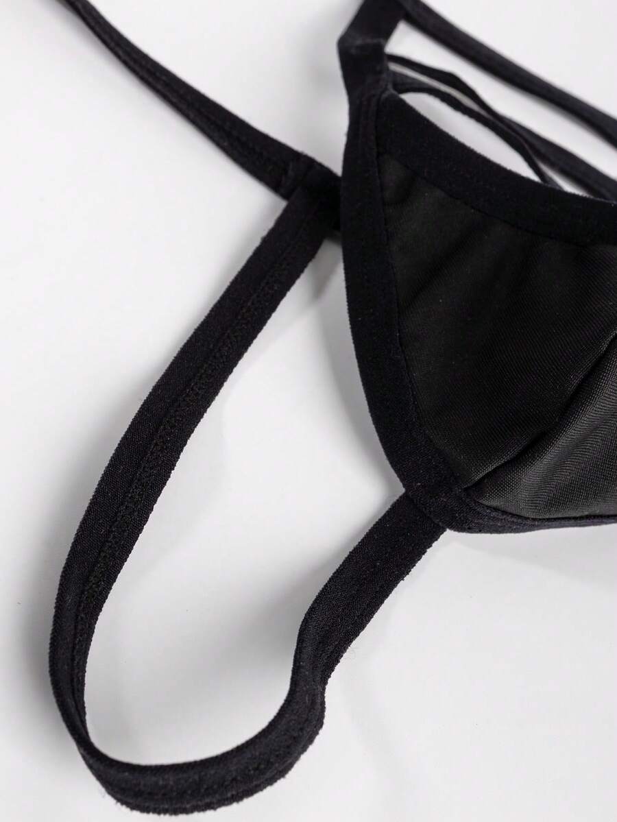 Black low-rise men's T-back thong underwear featuring an anti-slip design made from knitted medium-stretch fabric.