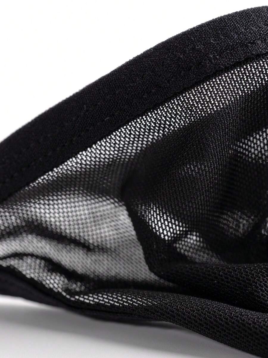Black men's hollow mesh thong underwear featuring a mid-rise waist and colorblock design.