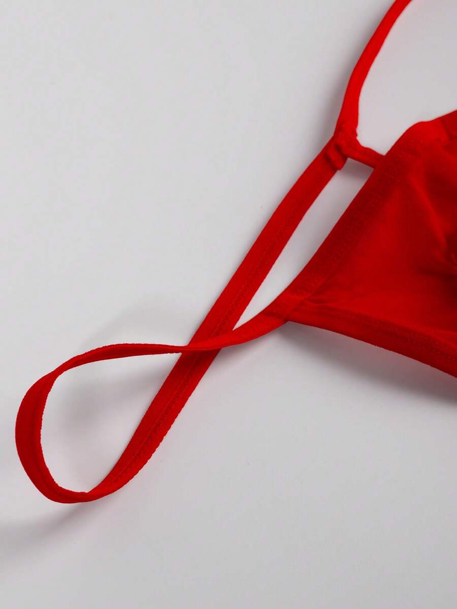 Men's red mesh thong underwear featuring a low-rise waist and hollow-out design.