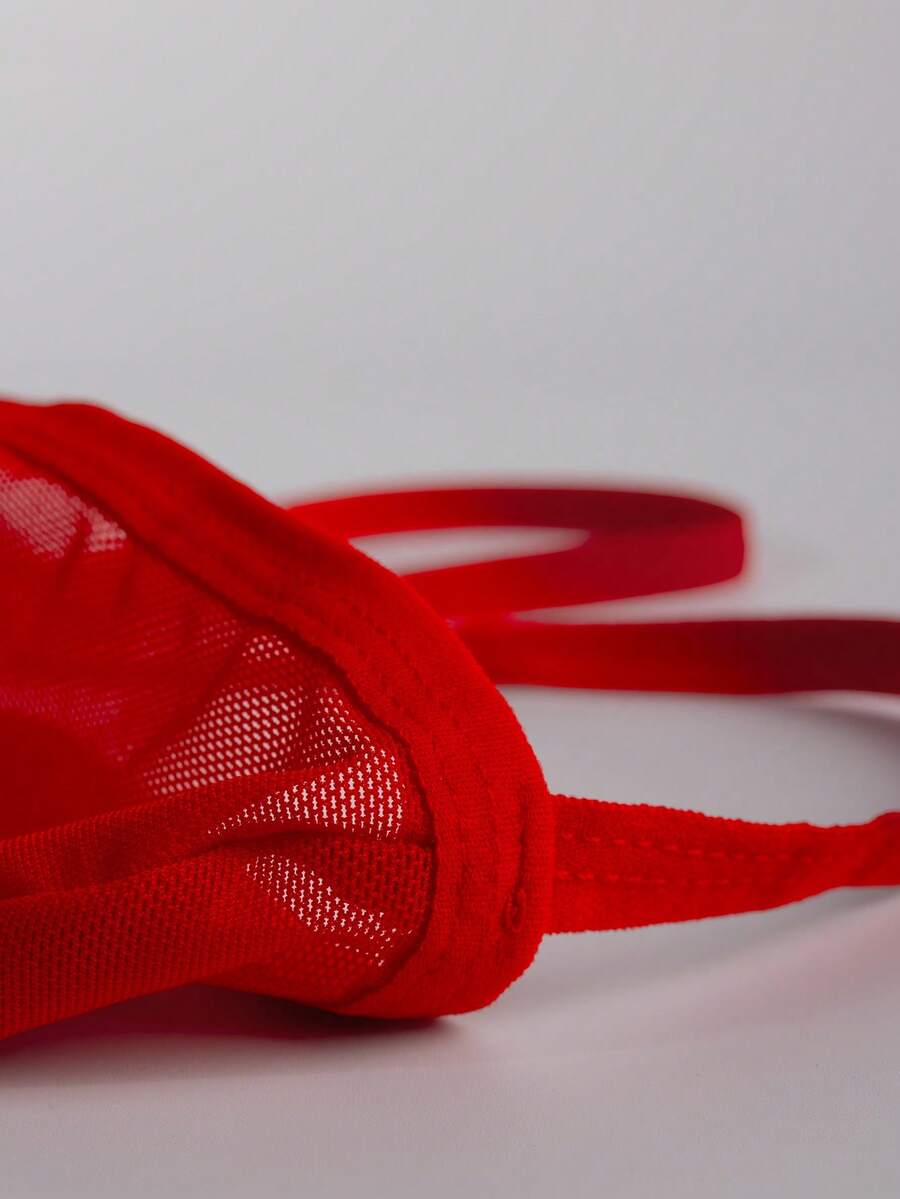 Men's red mesh thong underwear featuring a low-rise waist and hollow-out design.
