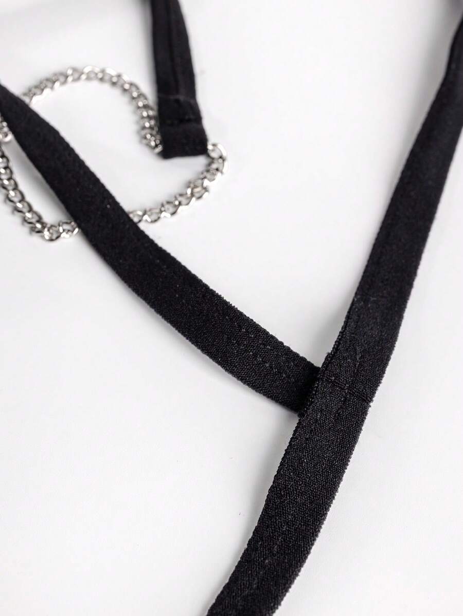 Black men's mid-waist thong underwear featuring a non-slip design and colorblock geometric letter pattern.