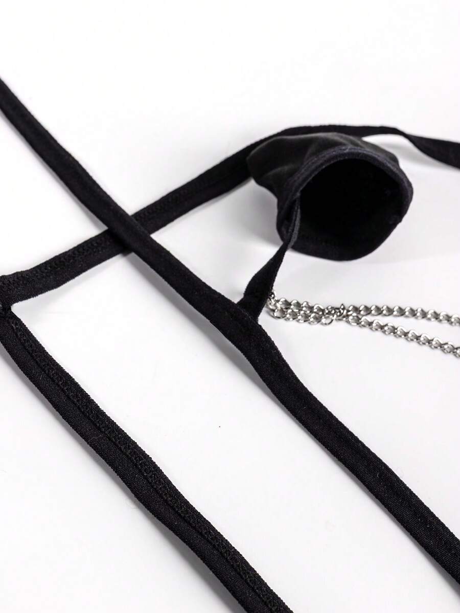 Black men's mid-waist thong underwear featuring a non-slip design and colorblock geometric letter pattern.