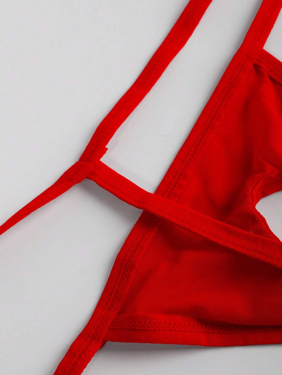 Men's red mesh thong underwear featuring a low-rise waist and hollow-out design.
