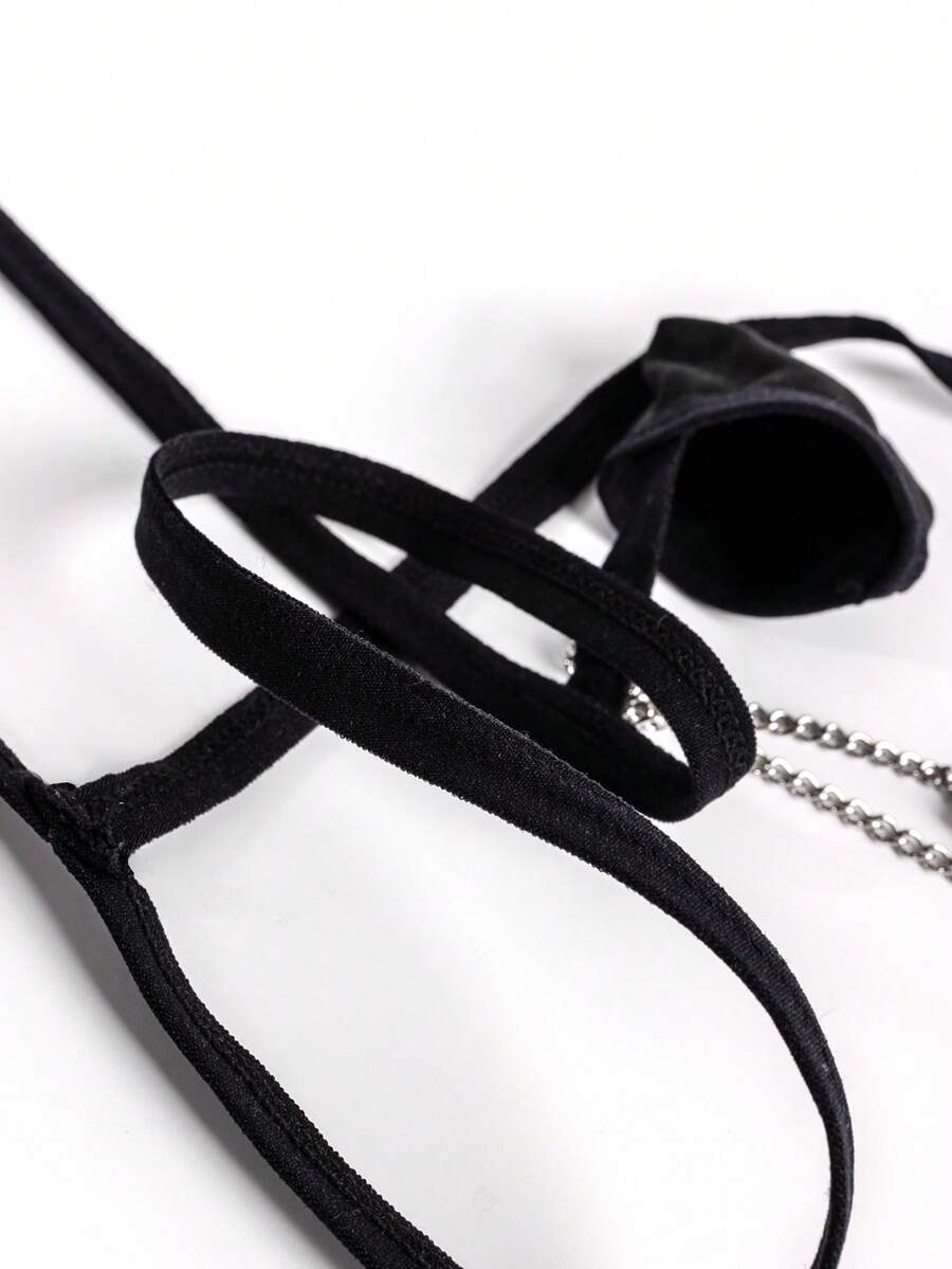 Black men's mid-waist thong underwear featuring a non-slip design and colorblock geometric letter pattern.