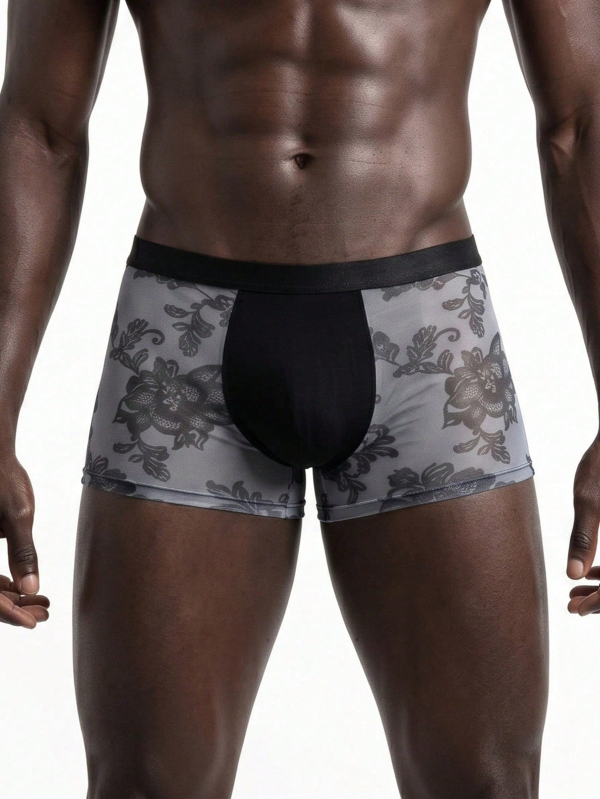 Men's grey low-rise semi-sheer mesh boxer briefs with plant pattern and contrast binding.