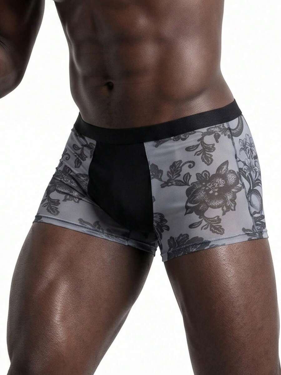 Men's grey low-rise semi-sheer mesh boxer briefs with plant pattern and contrast binding.