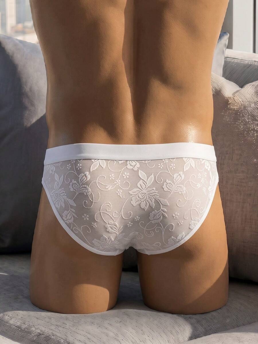 White low-rise men's lace thong underwear featuring a plant pattern.