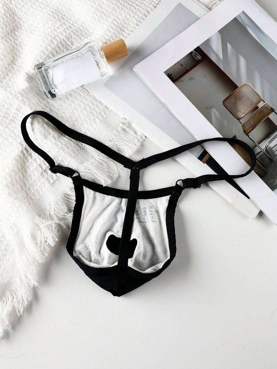 Black low rise men's thong featuring contrast binding detailing and a plain solid design.