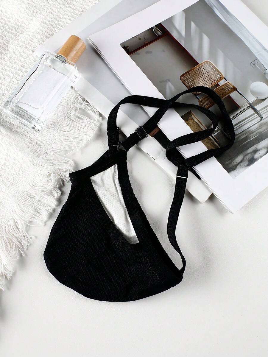 Black low rise men's thong featuring contrast binding detailing and a plain solid design.